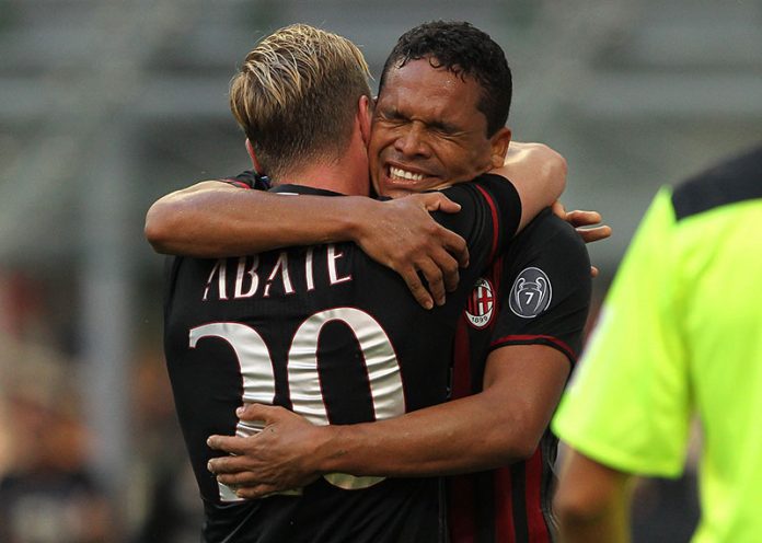 Carlos Bacca (R) of AC Milan celebrates with his team-mate Ignazio Abate (L) after scoring the opening goal during the Serie A match between AC Milan and FC Torino at Stadio Giuseppe Meazza on August 21, 2016 in Milan, Italy. (Photo by Marco Luzzani/Getty Images)